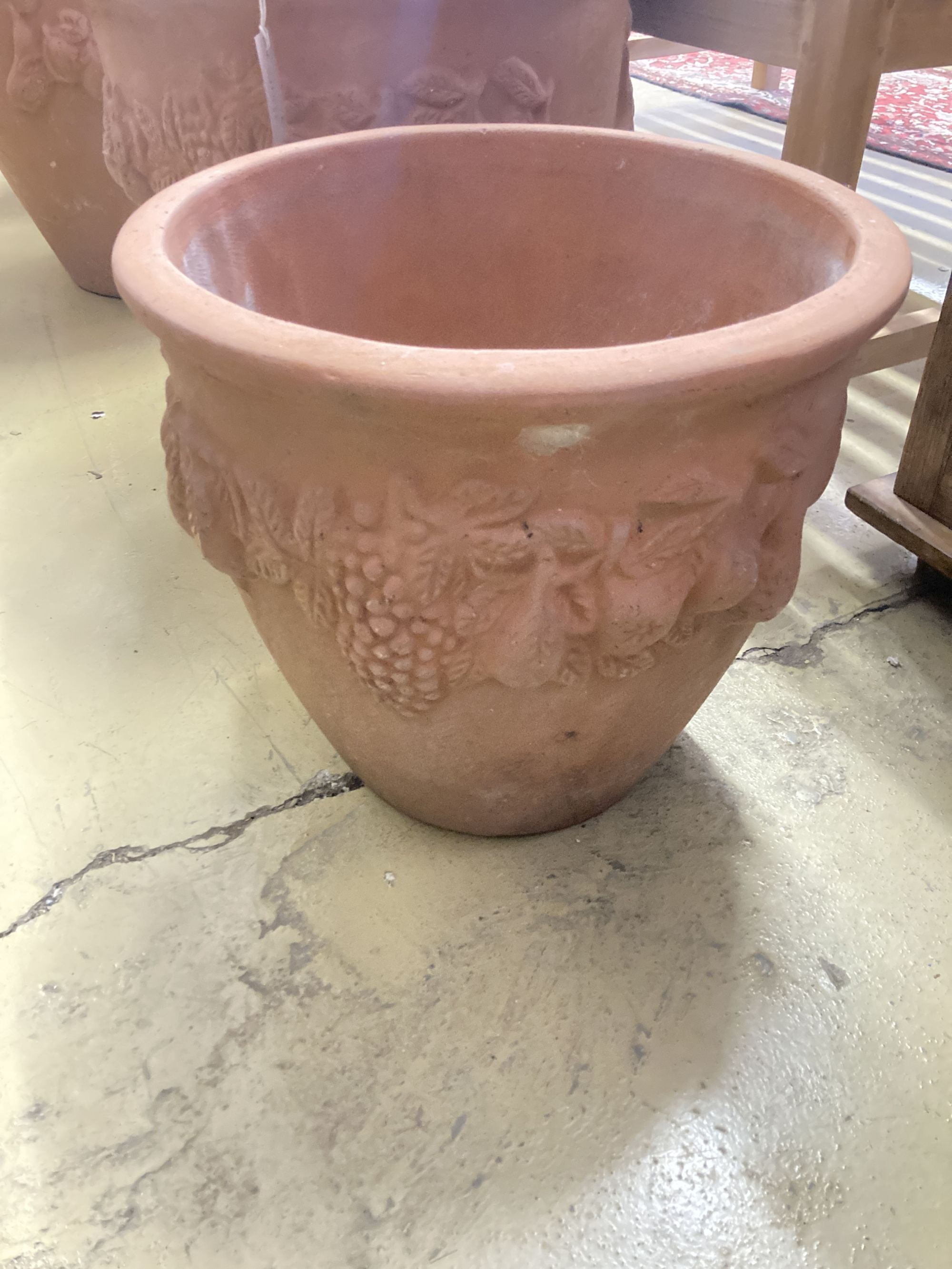 Four circular terracotta garden urns, largest 50cm diameter, 46cm high